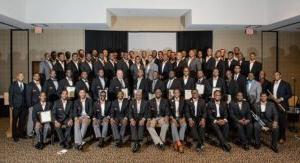 Photo of a large group of MISTERs posing wearing blazers and bow ties.